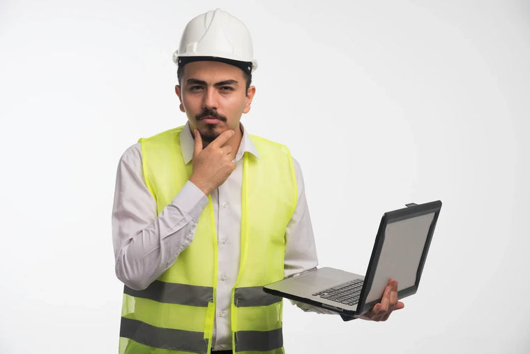 Safety manager preparing for IOSH Managing Safely on a laptop