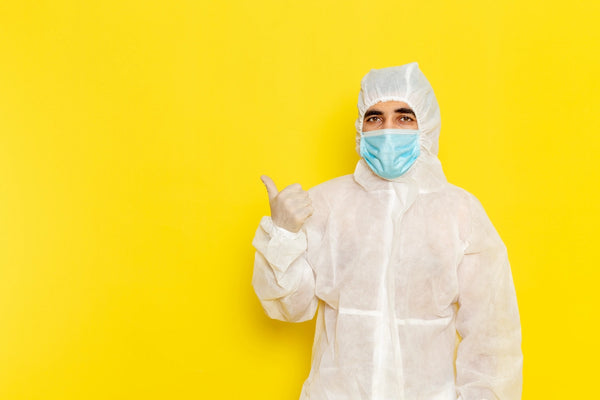 Technologist wearing PPE in pharmaceutical safety environment